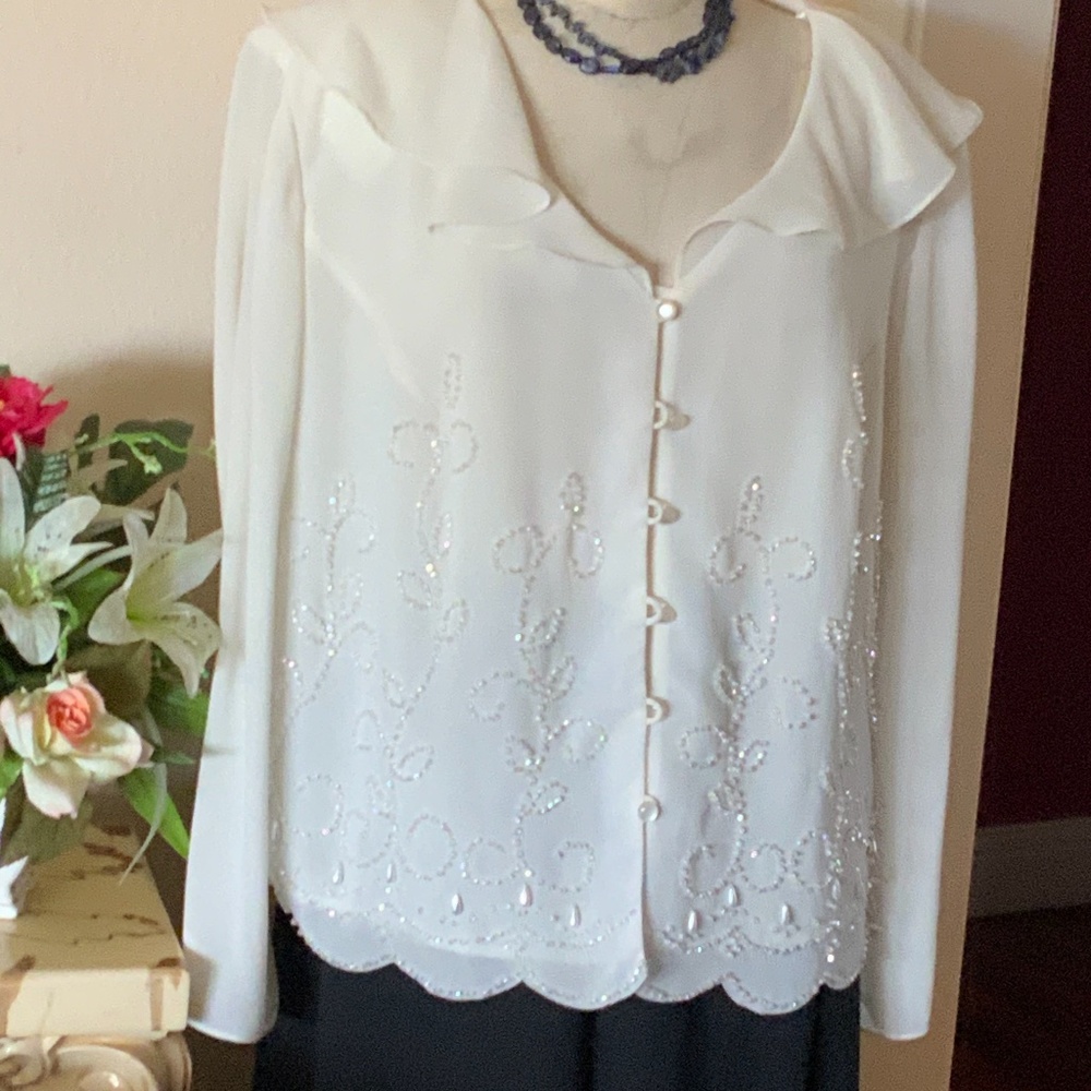 Cream colored long sleeve beaded top